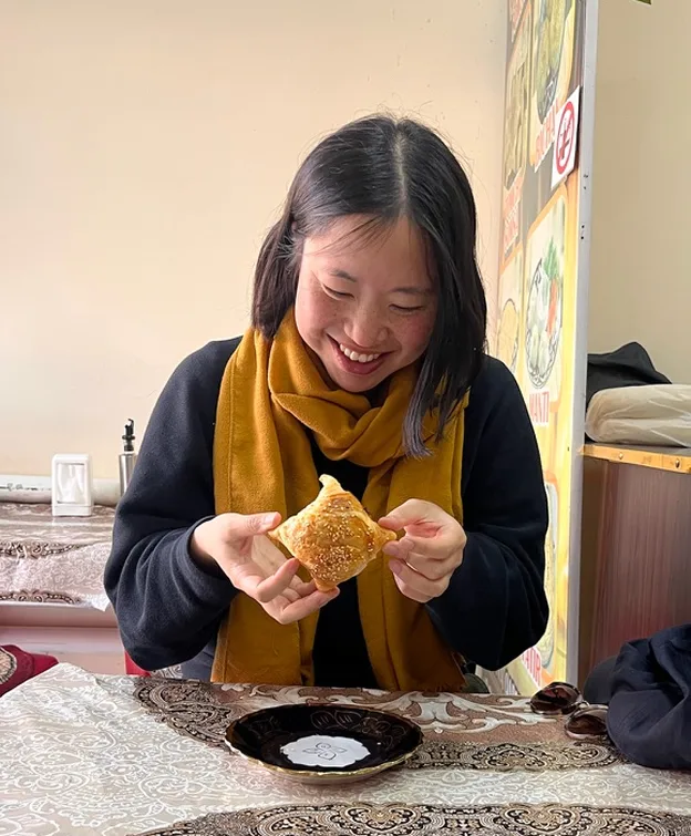 Meki eating a pastry